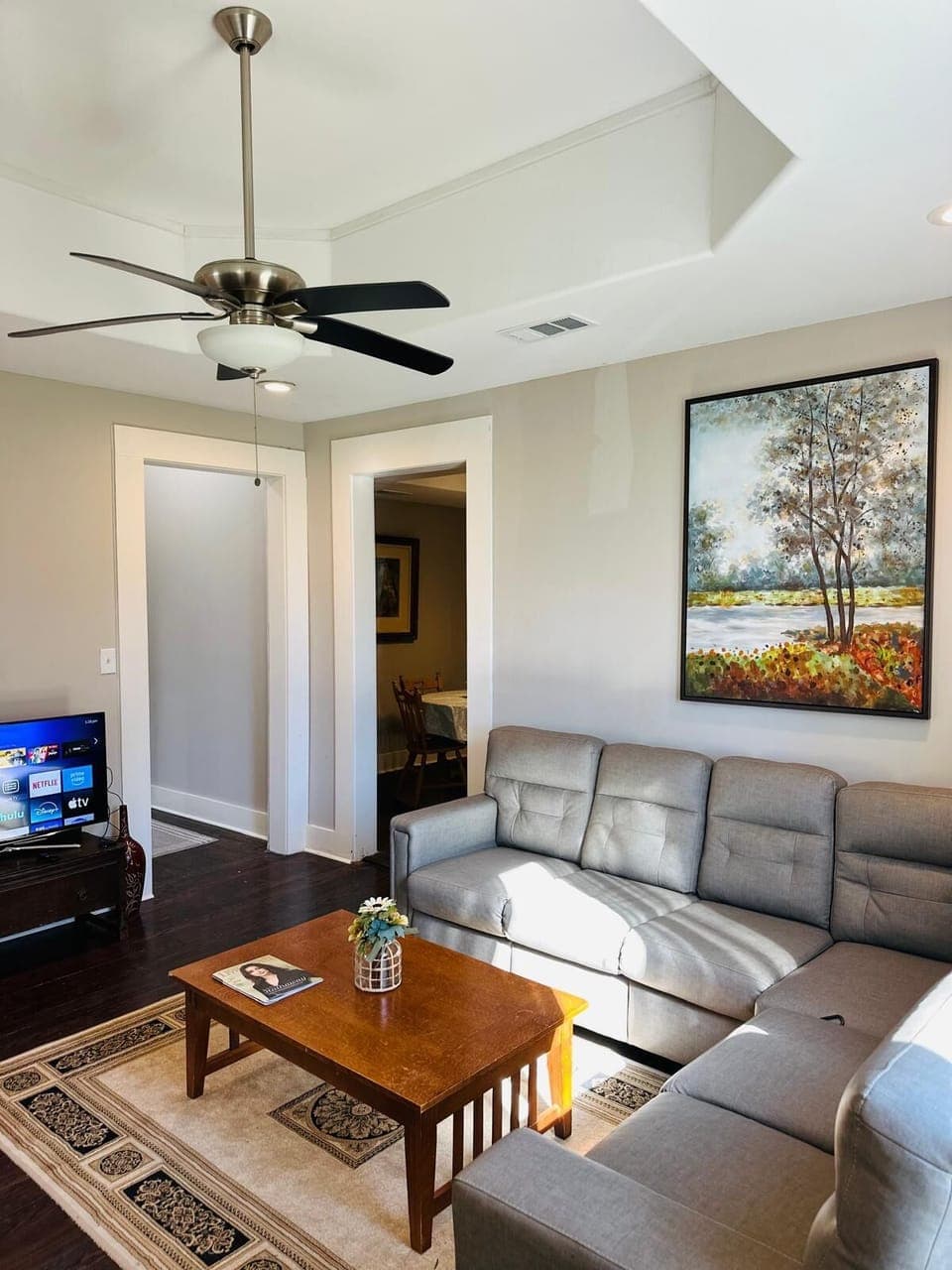 A spacious living with a sectional sleeper sofa, cozy recliner, and Smart TV