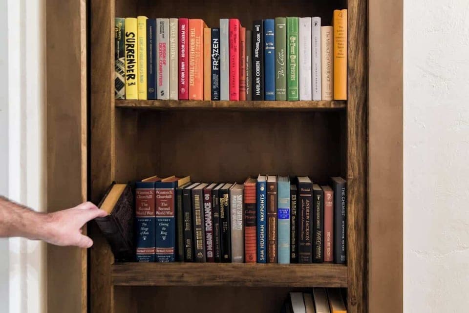 Book latch opens the bookshelf door that leads to a secret game room 