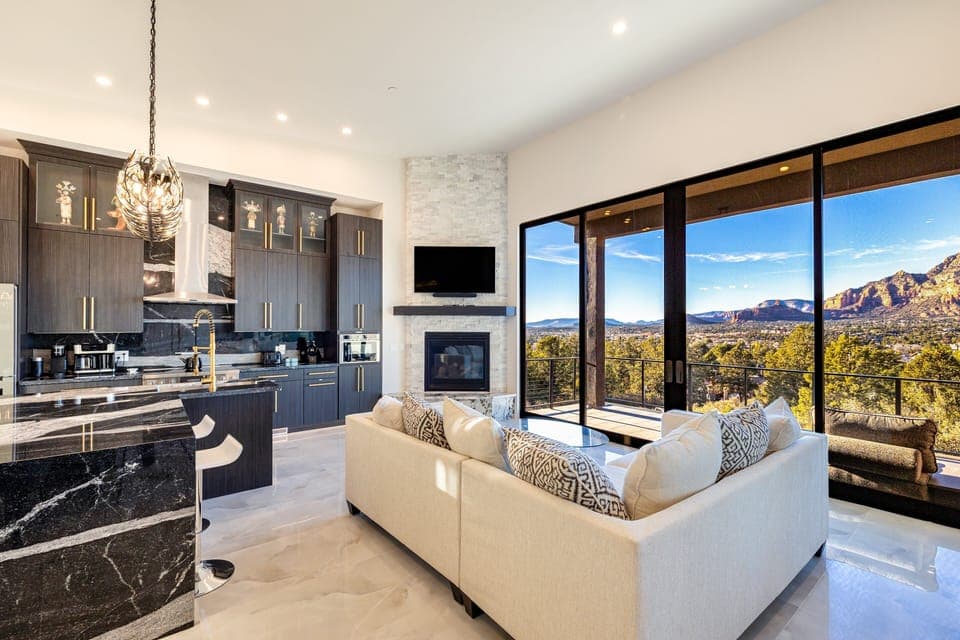 Step into Elegance: Zendona's expansive living room welcomes you with Red Rock views and cozy luxury. Perfect for relaxing by the fireplace or hosting a movie night.