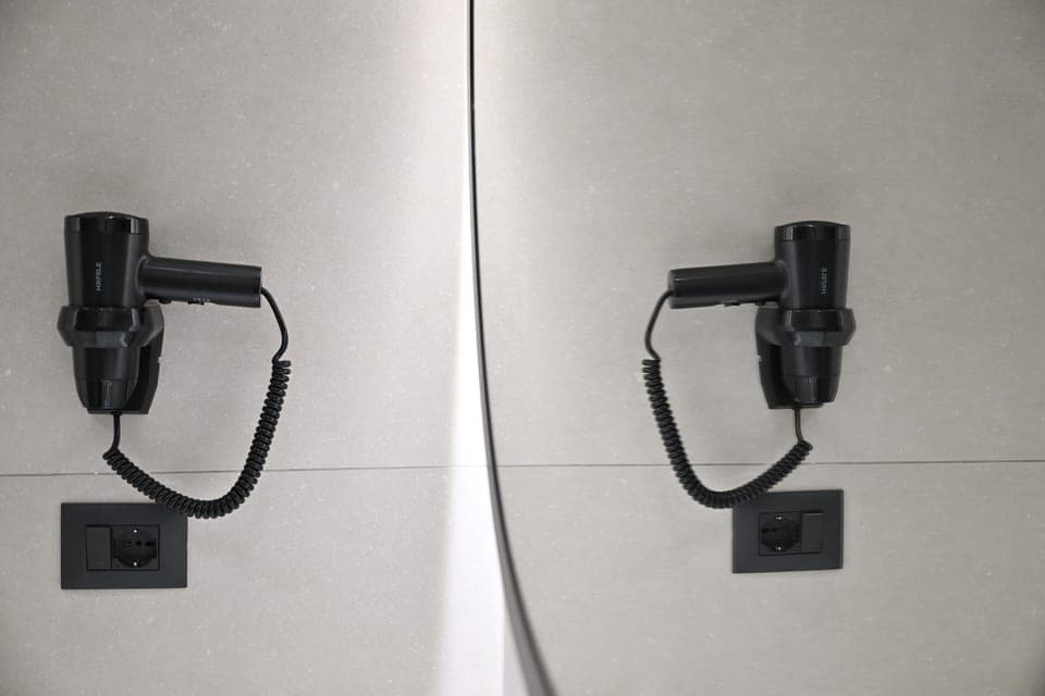 Shower, hair dryer, slippers, towels