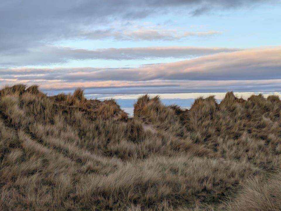 Over the Dunes there be the Sea, lapping at the Silvery Sands of the Beach