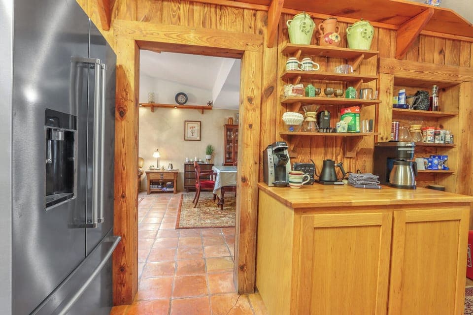 The kitchen is located off of the dining room