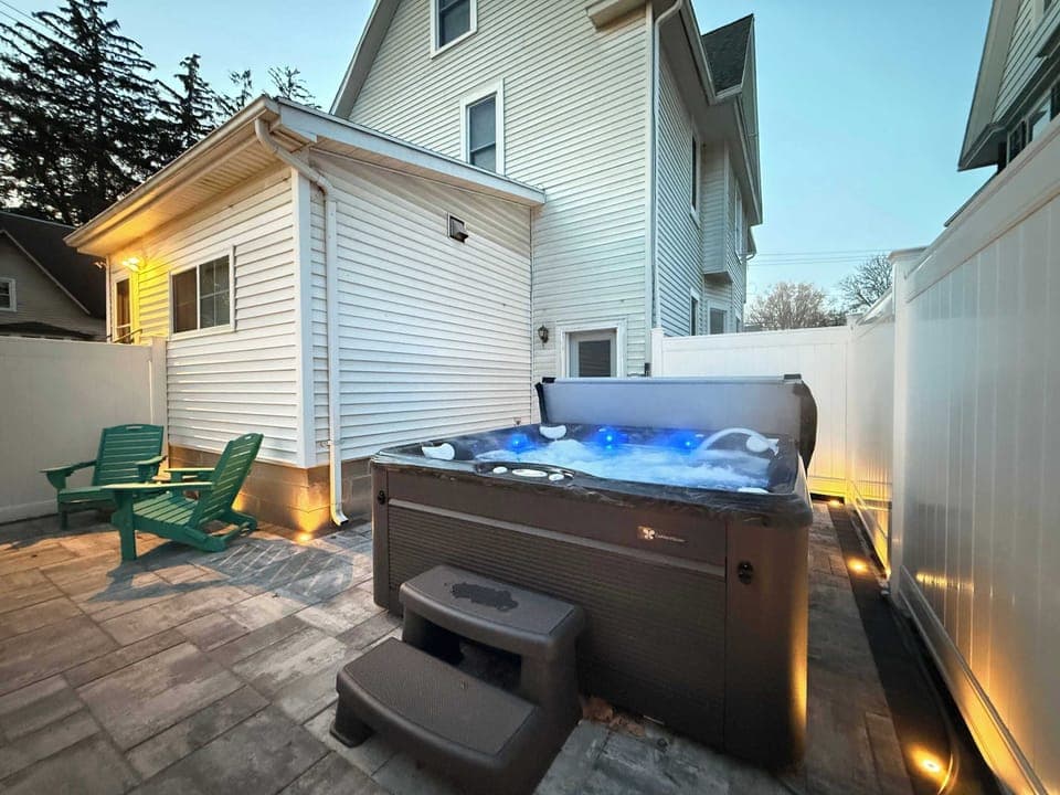 BRAND NEW Fully fenced in patio with a hot tub