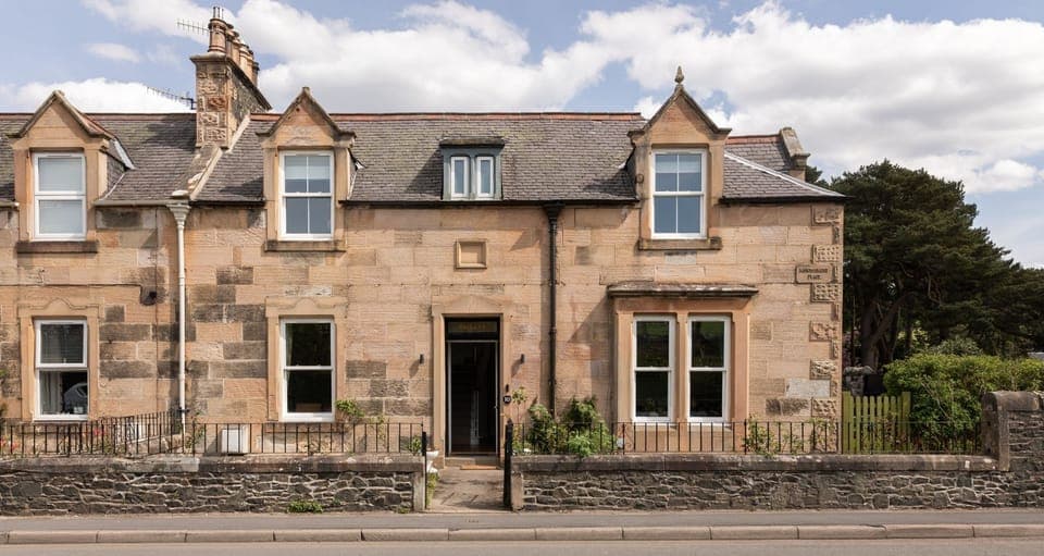 Dalgety - front garden with lawn and herbaceous border which is enclosed by a gate and wall