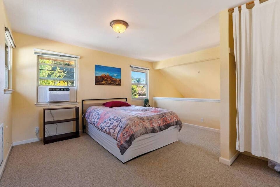 This sun-drenched sanctuary features a refined palette of warm ivory and plush textures, anchored by a designer sleeping quarters and a thoughtfully integrated dressing area concealed by flowing floor-to-ceiling drapery.