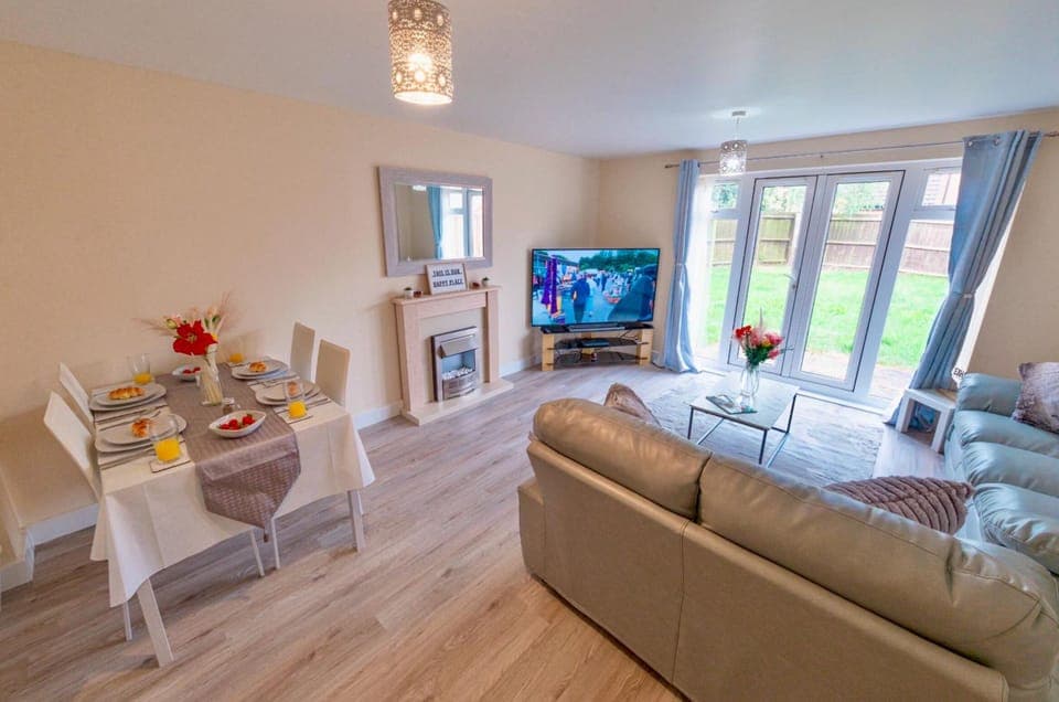 Living room with adequate seating, and dining area.