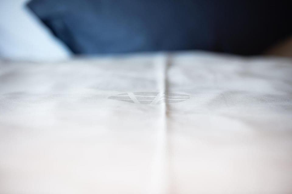 Premium bedding, desk, laptop workspace, soundproofing