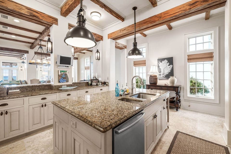 You'll love preparing meals in this stunning chef's kitchen with exposed beams, granite countertops, and gleaming appliances.