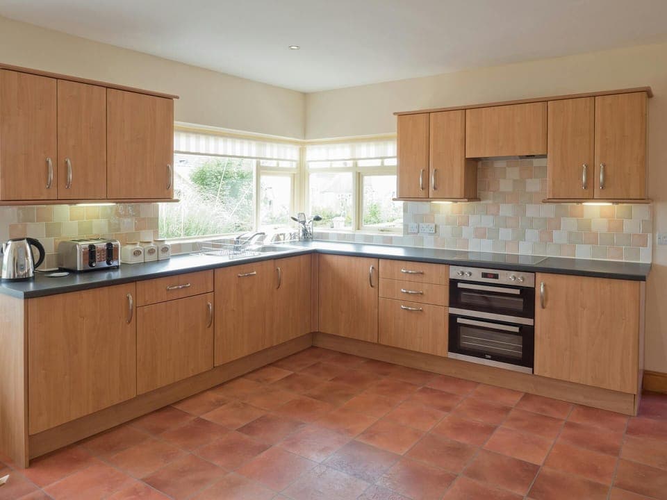 Kitchen cabinets, cooker, kettle, toaster and utensils