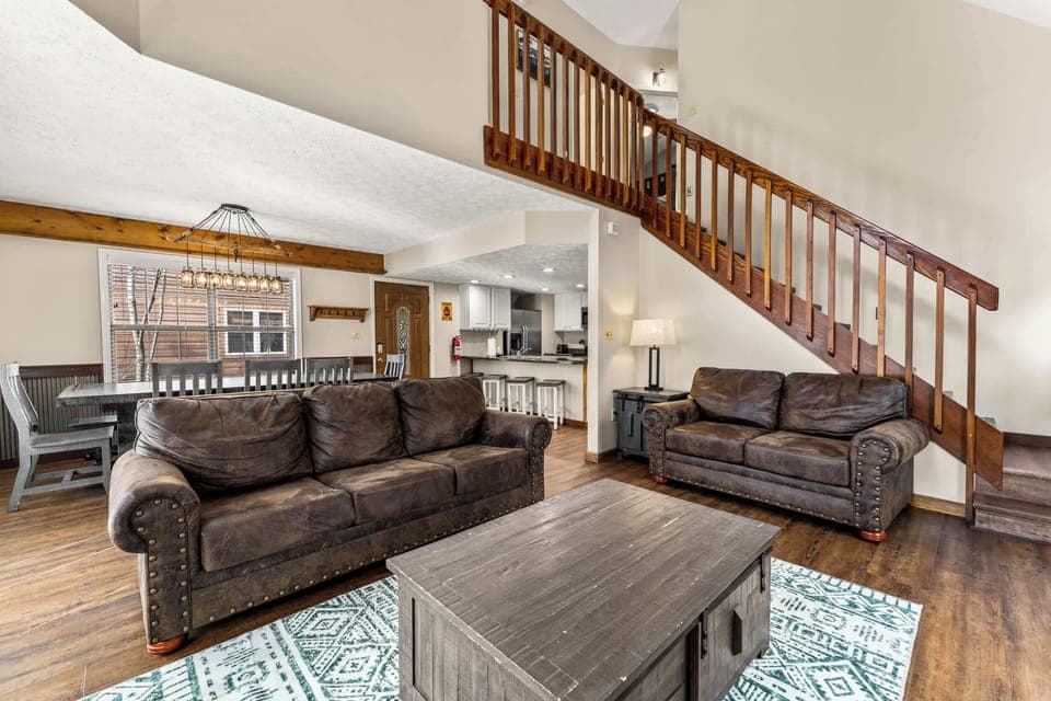 Open living area with sofa sleeper, gas fireplace, and Smart TV