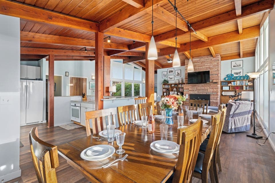 Dining area with ocean view open to living room and kitchen