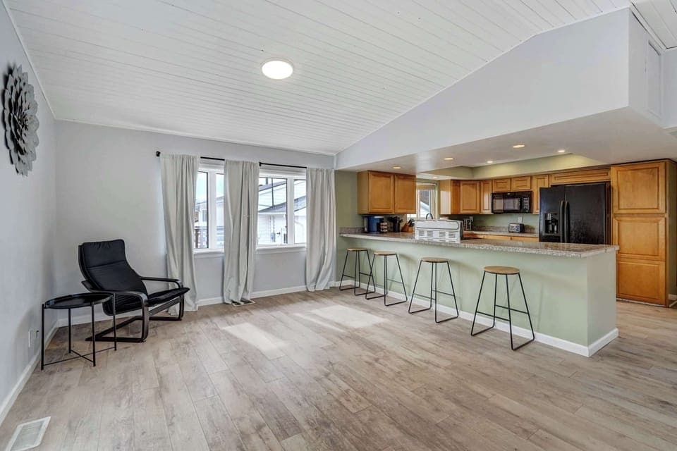 Bright and airy space with vaulted ceilings, large windows, and easy access to the outdoor deck—perfect for seamless indoor-outdoor living.






