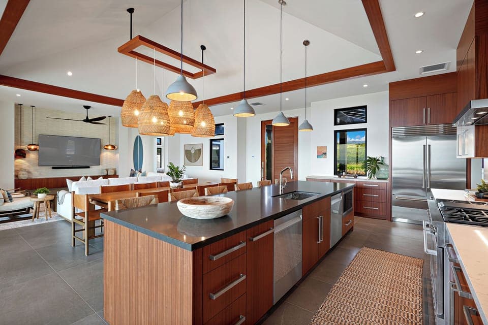 Gather in the spacious kitchen with a large island, sleek appliances, and modern lighting.