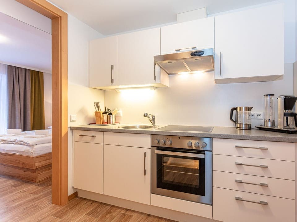 Kitchen in the holiday apartment Appartements Hollin in Saalbach by we rent apartments, with a stove, oven, and fully equipped.