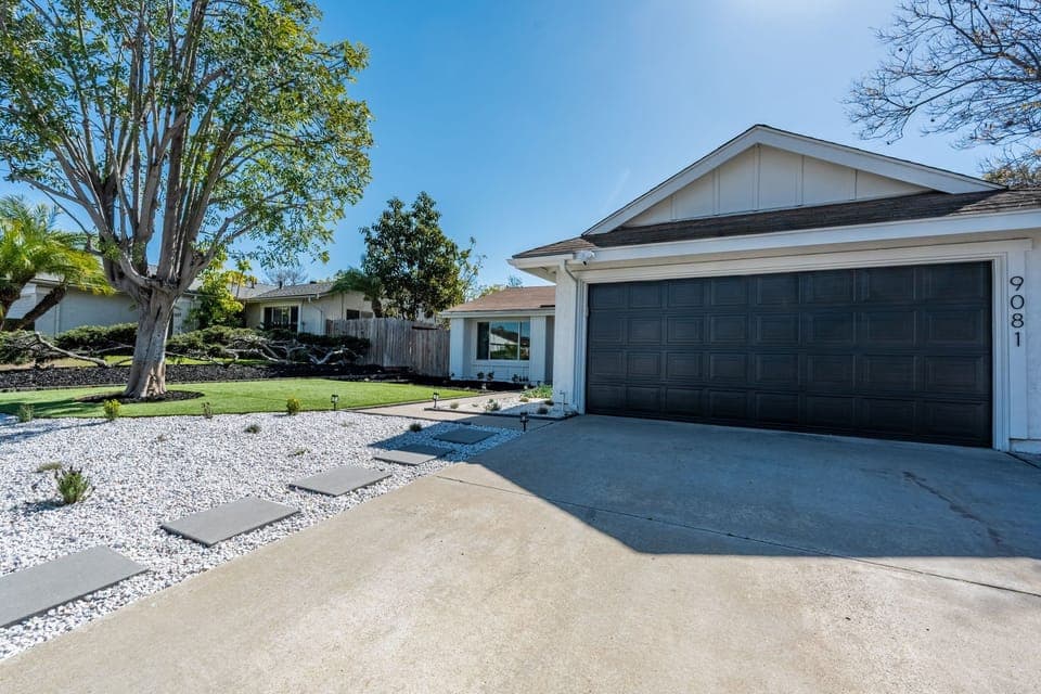 Welcoming home with 2-car garage and beautifully landscaped yard.