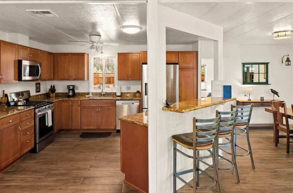 Fully equipped kitchen with modern appliances and a breakfast bar for easy meals.
