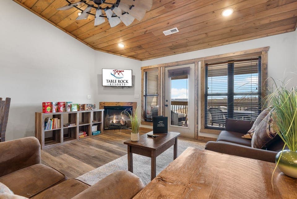 Living Room with Cable TV, Fireplace, Various Board Games, Sleeper Sofa, and Deck Access