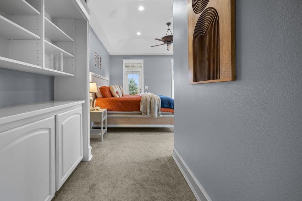 Entry to the primary bedroom is ideally situated just off the home office and main living area.