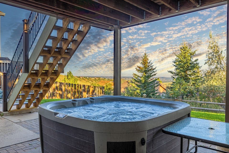 Wake up to sweeping mountain views, relaxing in the hot tub at The Vista House, a spacious 4-bedroom retreat in Colorado Springs.