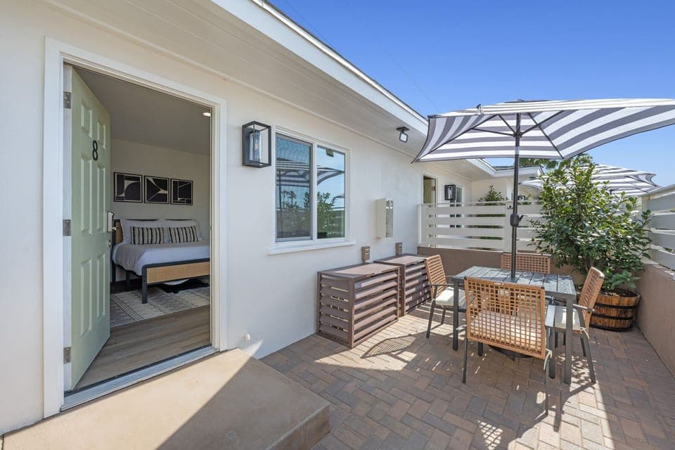 Enjoy your semi-private patio, featuring a table and umbrella, where you can relax and embrace the refreshing ocean breeze.