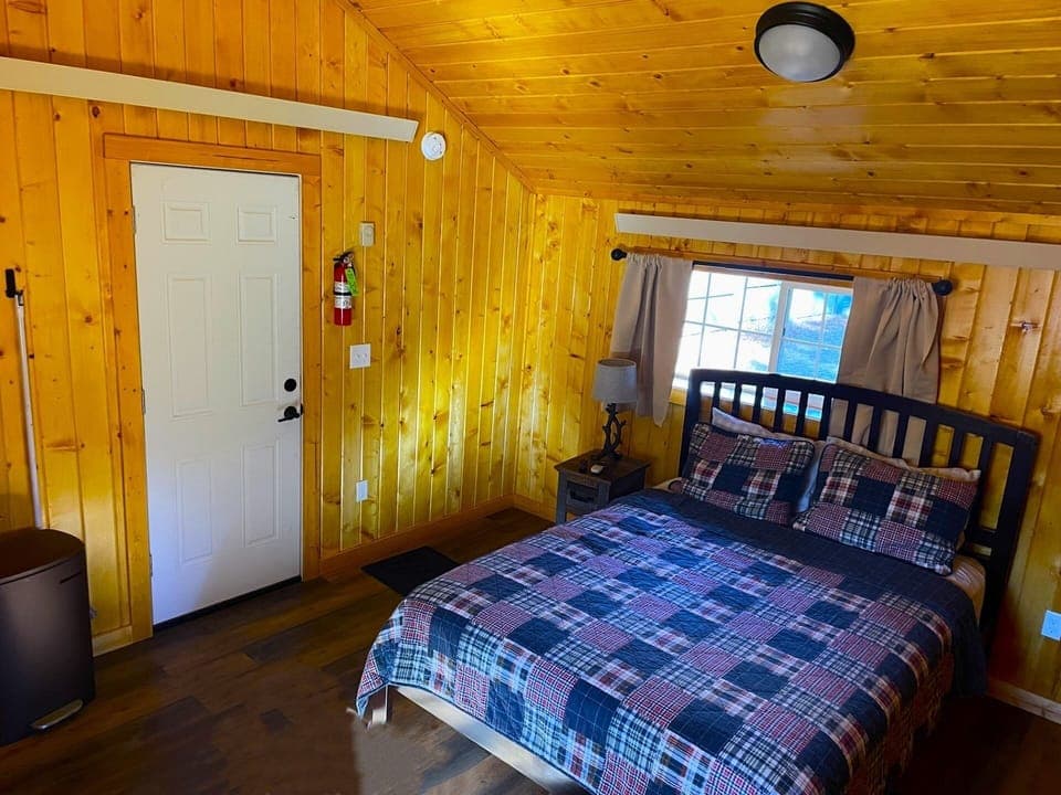 Drift off in a comfy bed under warm wood ceilings.