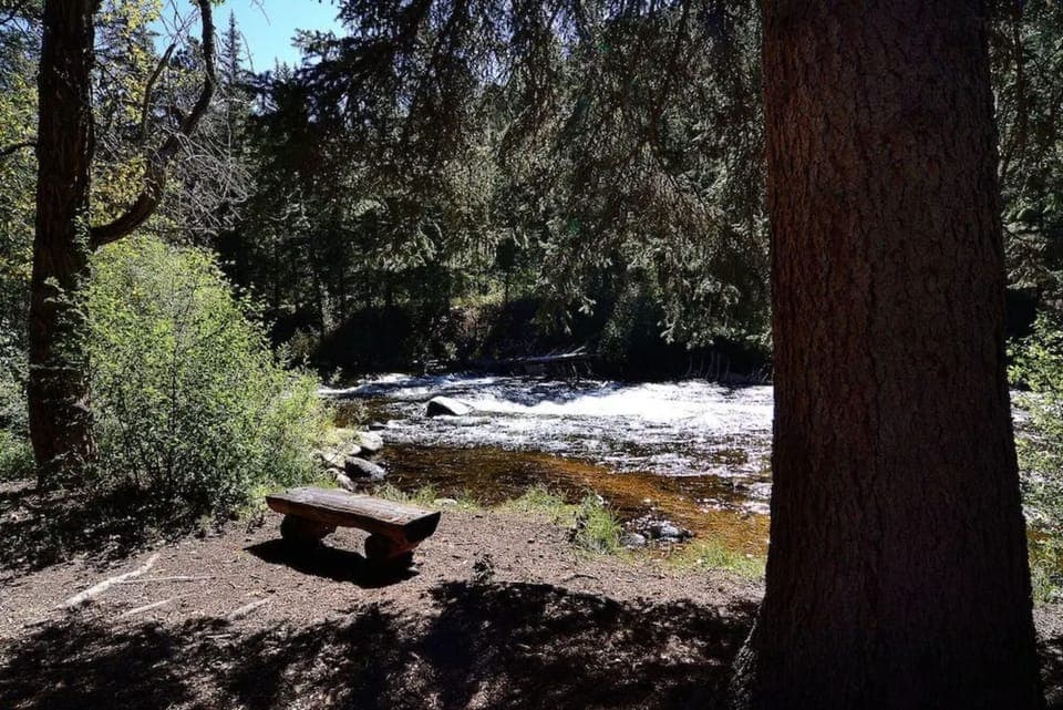 Pause on the shaded bench and listen to the rapids.