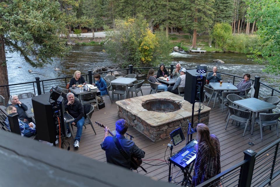 Gather by the riverside firepit for live evening music.