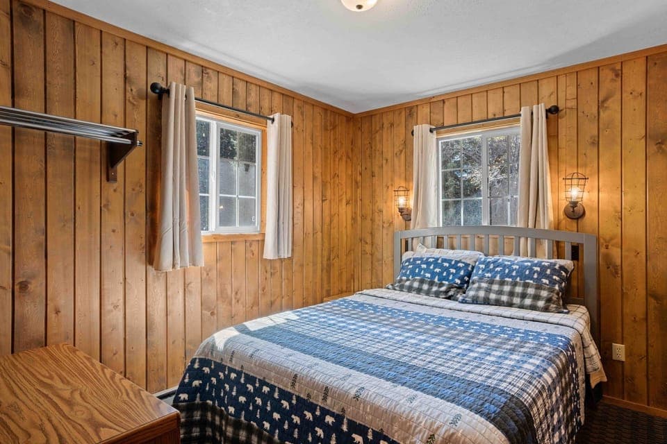Sleep soundly in a warm wood-paneled, cabin-style room.