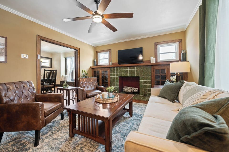 Main living area with plenty of seating options, natural light, fireplace, and smart TV.