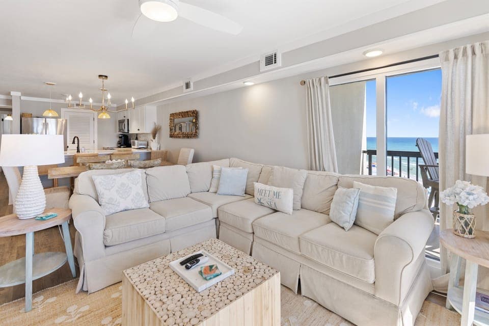 Relax in your bright coastal living space where ocean views frame every moment through floor-to-ceiling windows.
