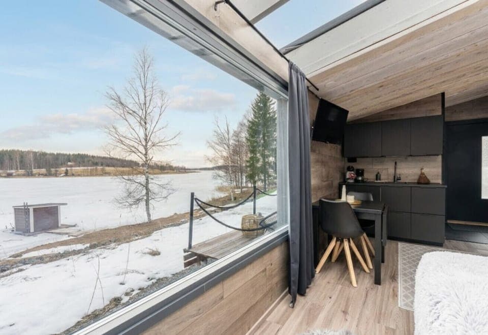 The studio`s open-plan layout is designed to immerse you in the breathtaking scenery. From the modern kitchenette to the cozy dining area, the entire space is oriented toward the stunning, unobstructed views of the tranquil lake and surrounding nature.