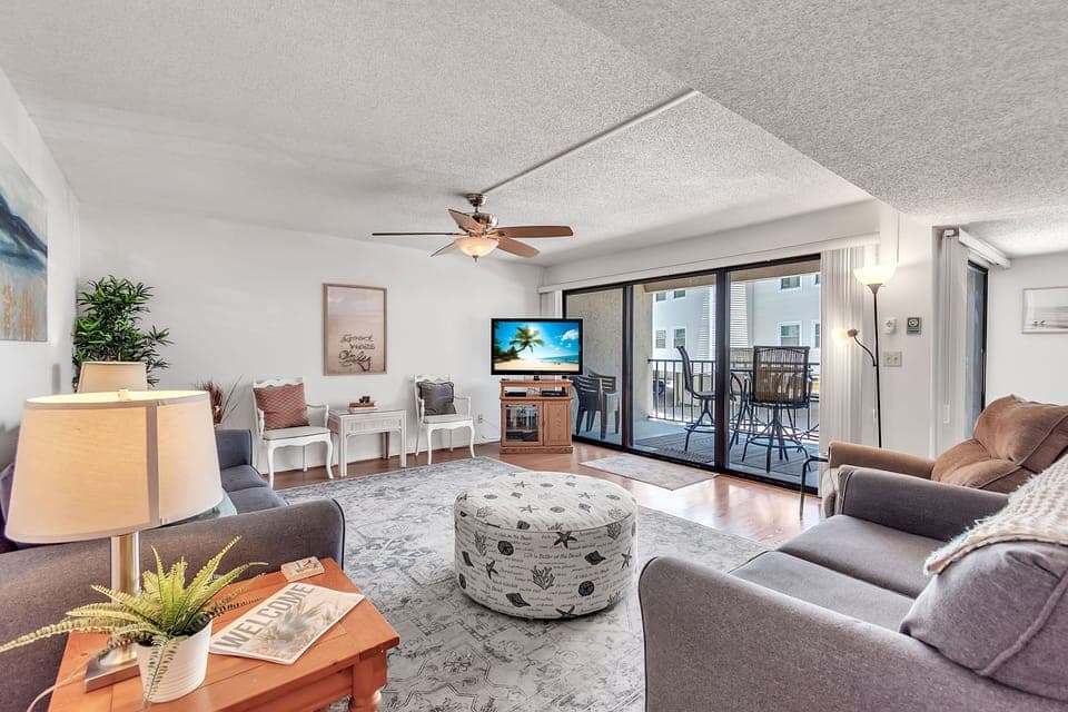 Welcome to Sea Haven! Spacious living room with balcony access