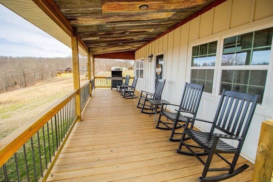 Relax on the covered porch with rocking chairs and savor sunrise coffee or sunset wine overlooking the Ozarks.