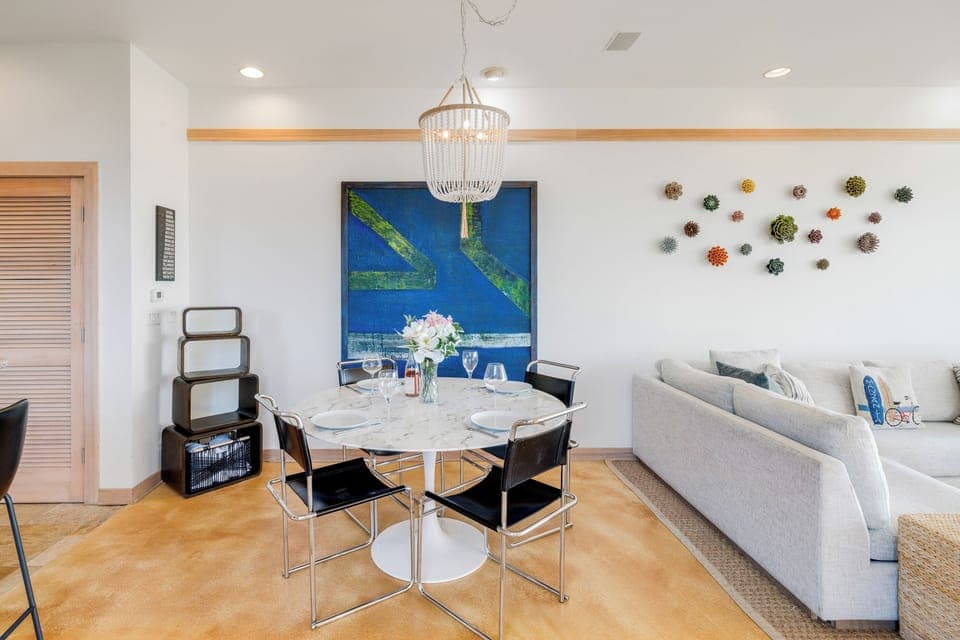 Ocean view dining room open to living room with gas fireplace, Dish and streaming TV, French doors to outside.