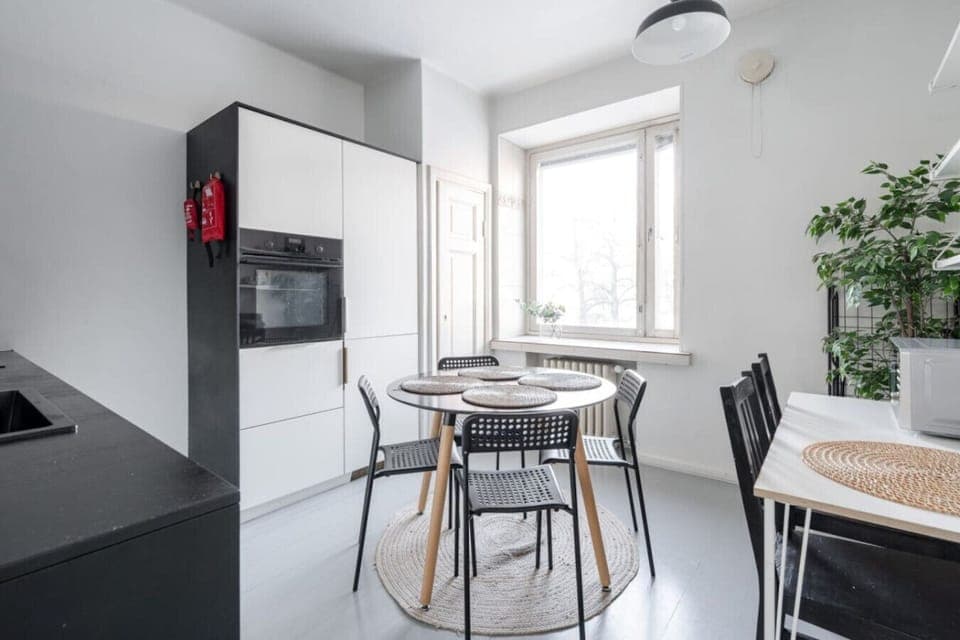 Apartment kitchen that includes oven, microwave, stove, cooker hood, washing machine and a dishwasher for instance