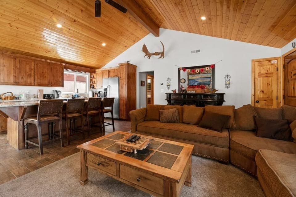 Gather around in our inviting living room, where rustic charm and modern comfort meet by a warm fireplace