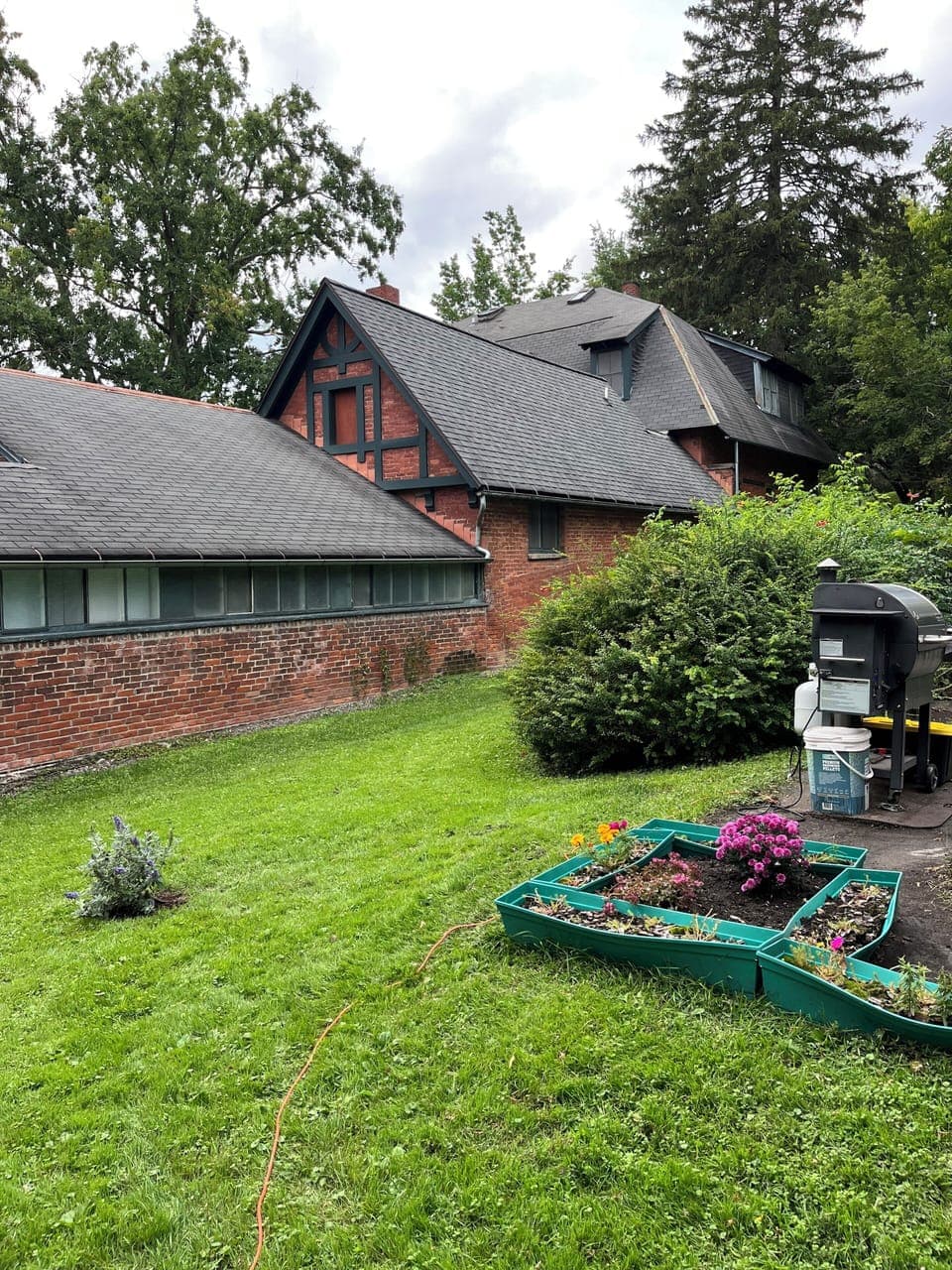The backyard is private and green with parking and patio/grill in tow.