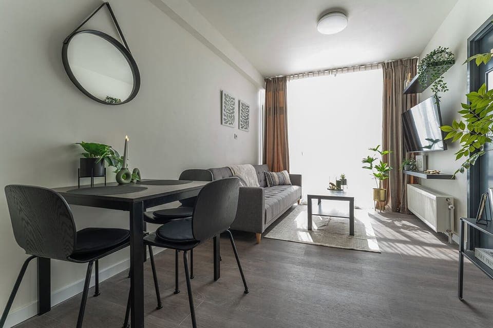 Bright and cozy living space with a stylish dining area, modern decor, and plenty of natural light for a relaxed stay.
