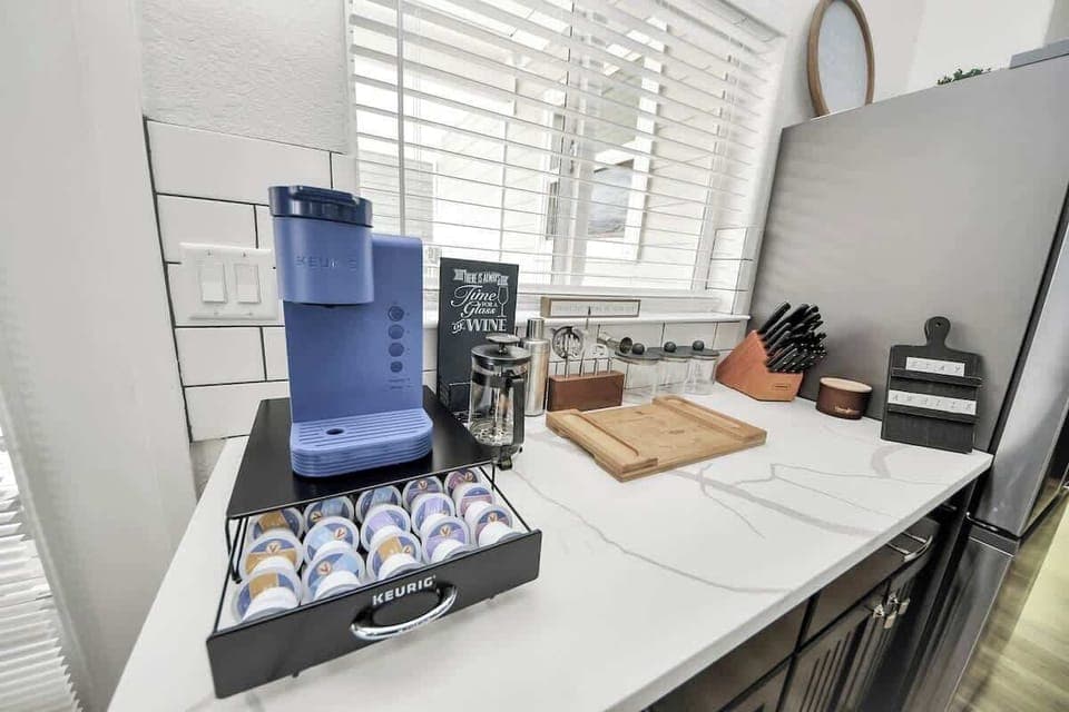 Enjoy a coffee on us! Just pick your favorite flavor from the tray below. This area also includes a corkscrew, shakers, & all the things for mixing up your favorite cocktail. A brand new knife set is also included to make life easier :)