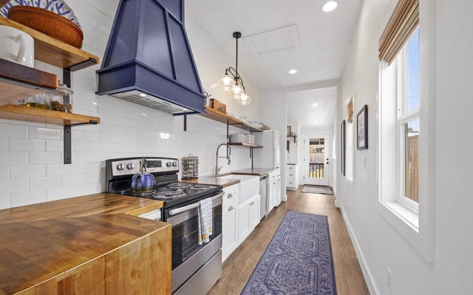 Modern kitchen with ample counters, and chic design