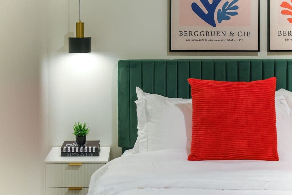 ✨ Stylish King bedroom with velvet headboard and statement decor.