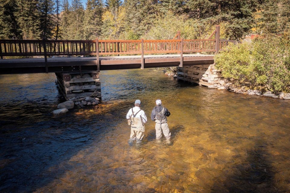 Wade into clear waters for peaceful riverside fly-fishing.
