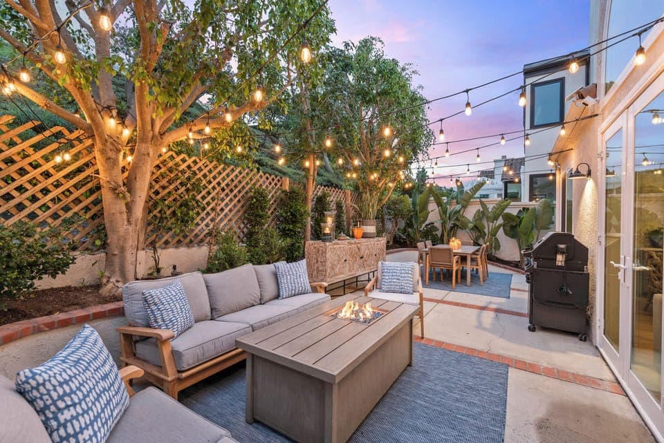 Relax under twinkling lights in this cozy patio setting.