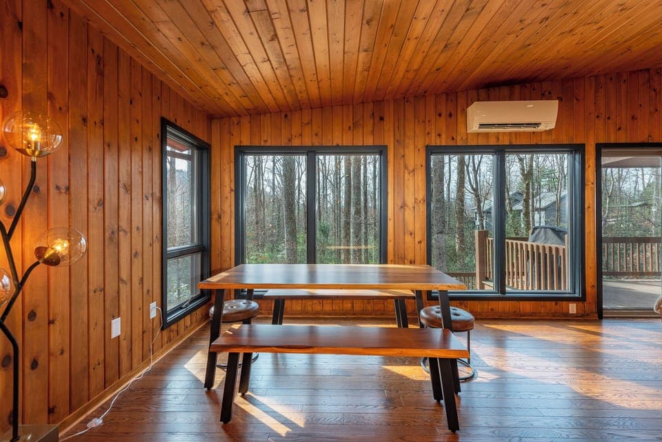 Open-concept living room with gas log fireplace and dining area for 8