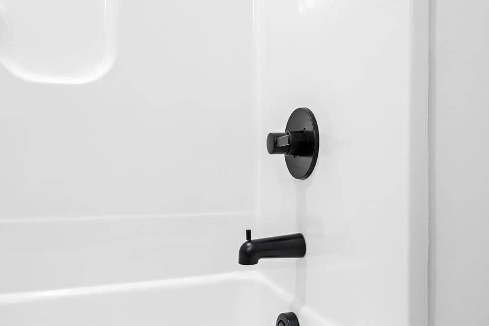 Bathroom: Simple and elegant—your shower features modern black fixtures for a sleek finish.