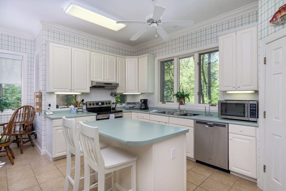 Kitchen with drip-style coffee pot, breakfast nook for 6, and island seating for 2