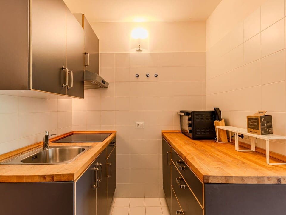 Countertop, Kitchen, Flooring, Cabinetry, Interior Design, Floor, Wood, Ceiling, Kitchen Appliance, Major Appliance