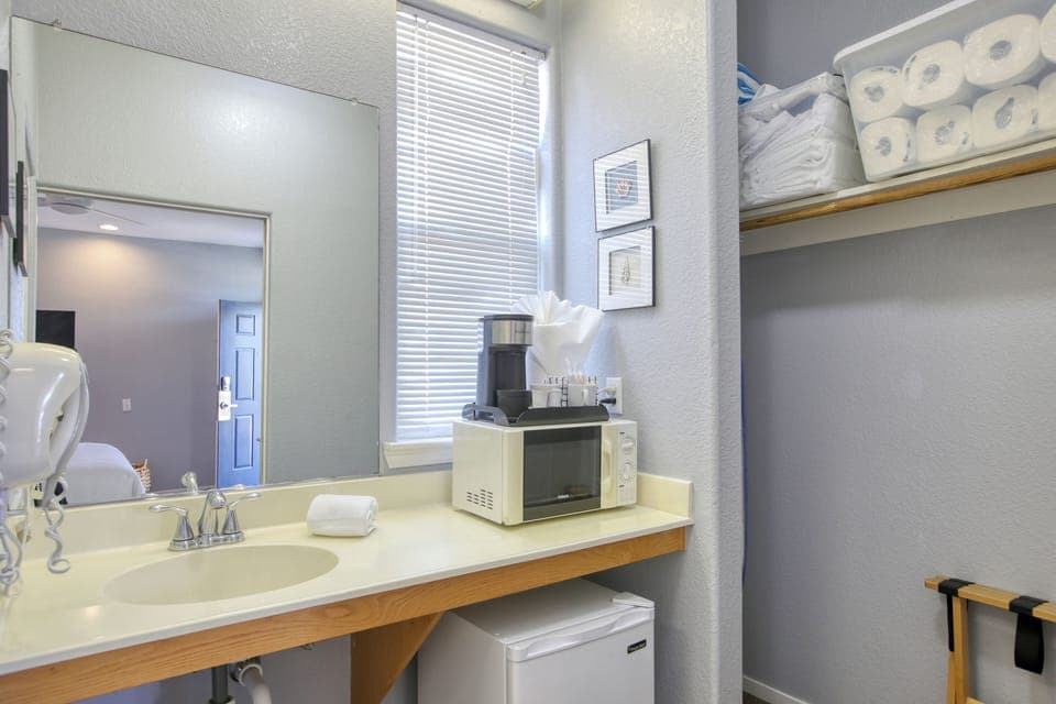 Compact kitchenette has a mini fridge, microwave, and kcup coffee maker—perfect for quick beachside bites.