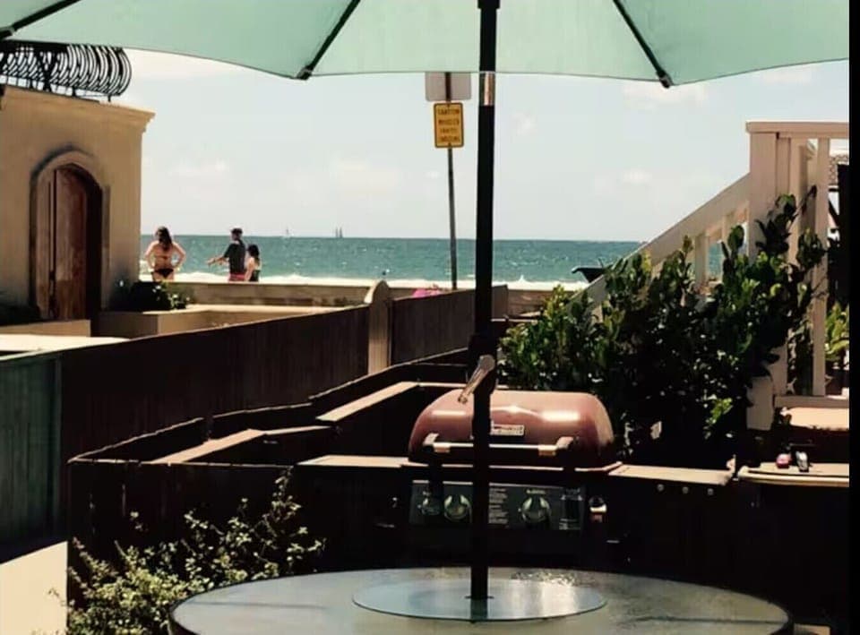 Sit down ocean view from large ,shared patio with tables, bbqs, hot tub, etc.