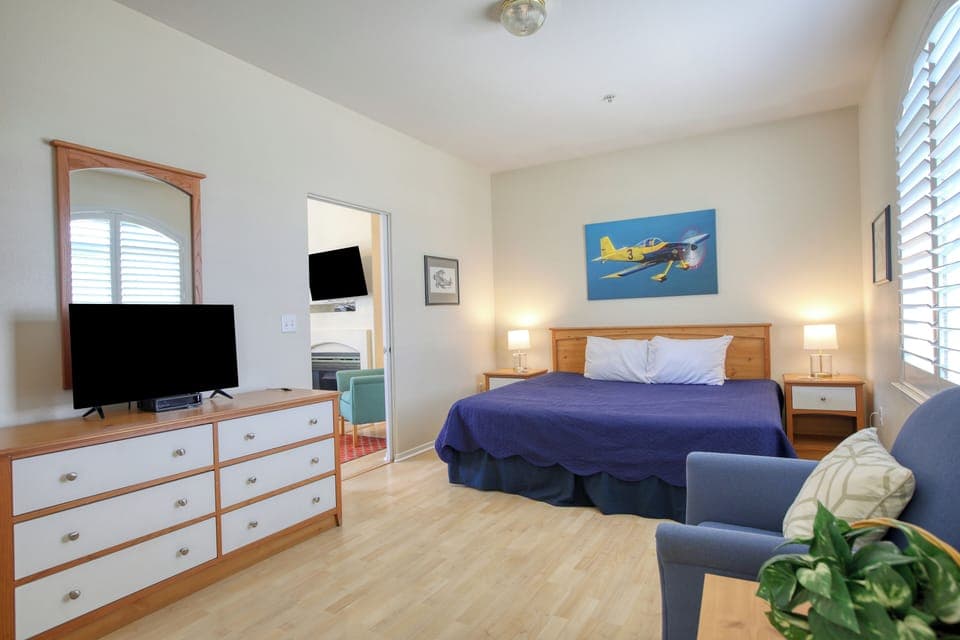 A spacious bedroom with a luxurious king bed, offering comfort and relaxation just moments from the beach.